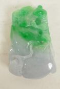 A Chinese carved jade pendant in the form of a kylin climbing a large gourd, 2" long