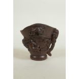 A Chinese carved bamboo libation cup decorated with climbing kylin, seal mark to base, 3" high