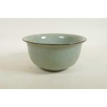 A Chinese celadon crackle glazed porcelain bowl, raised seal mark to base, 8½" diameter