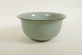 A Chinese celadon crackle glazed porcelain bowl, raised seal mark to base, 8½" diameter