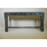 An Indian hardwood low table, with carved frieze and metal strap mounts, raised on turned supports