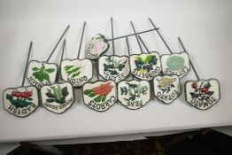 A set of twelve painted cast iron vegetable and herb markers, 14" long