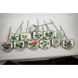 A set of twelve painted cast iron vegetable and herb markers, 14" long