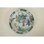 A Chinese famille verte porcelain charger, with a figure in front of a screen, 6 character mark to