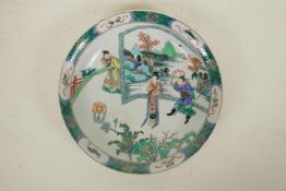 A Chinese famille verte porcelain charger, with a figure in front of a screen, 6 character mark to