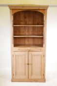 A Victorian pine open bookcase with turned decoration and two doors to base, 36" x 18", 79" high