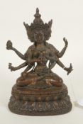 A bronze Buddhistic figure with eight arms, seated upon a lotus throne, pendant 2" high