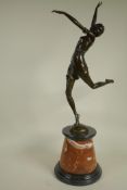 An Art Deco style figure of a dancing girl on a marble plinth, 26" high