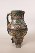 A North African pottery ewer with metal mounts, A/F repair to rim, 7½" high
