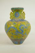 A Chinese Fahua glazed porcelain vase with two handles decorated with a dragon, phoenix and
