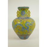 A Chinese Fahua glazed porcelain vase with two handles decorated with a dragon, phoenix and