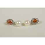 A pair of 9ct gold earrings set with an orange topaz encircled by diamonds, and pearl drop