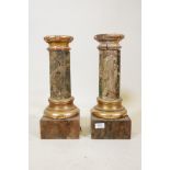 A pair of antique painted faux marble and parcel gilt columns, A/F historic woodworm damage to