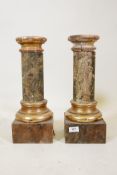 A pair of antique painted faux marble and parcel gilt columns, A/F historic woodworm damage to