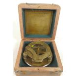 A brass sundial compass in a hardwood box, 4" diameter
