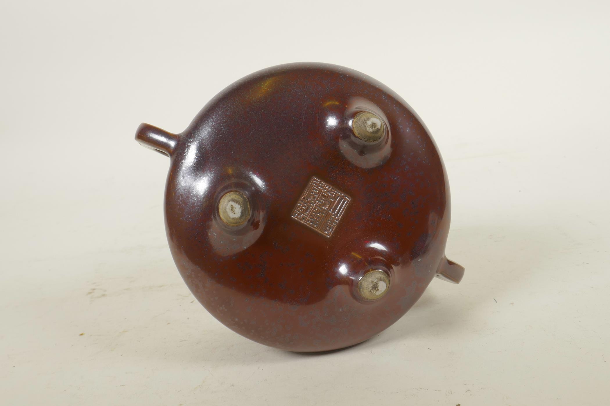 A Chinese copper glazed porcelain censer with two handles, raised on tripod supports, impressed seal - Image 4 of 6