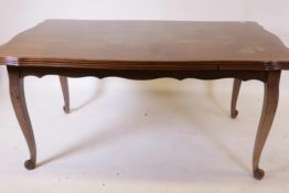 A French oak drawleaf dining table, with parquetry veneered top and pull out leaves, raised on