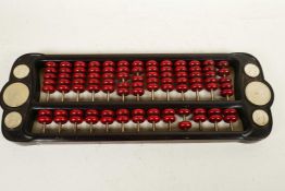 A Chinese hardwood abacus, the frame set with various coins, 16" long