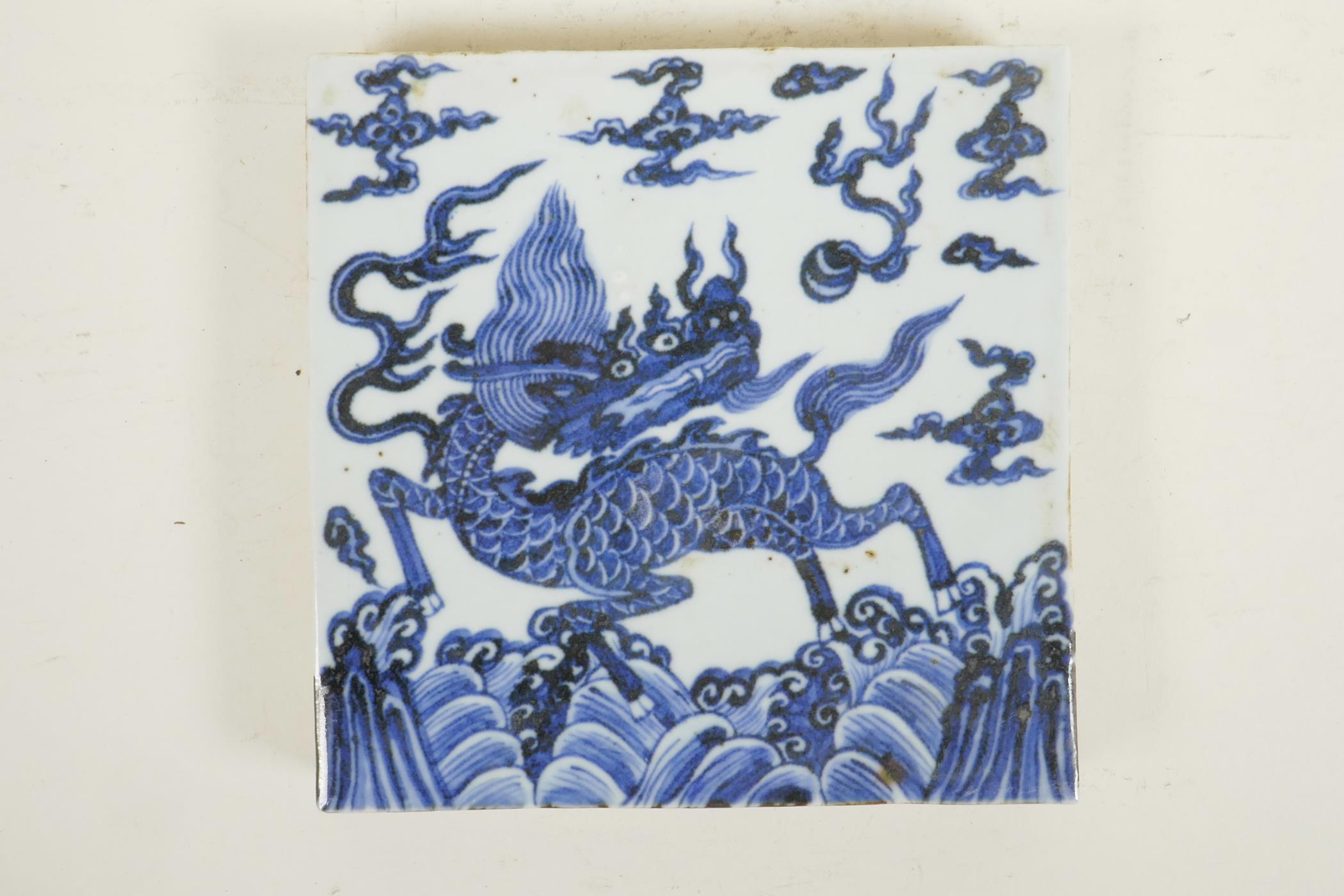 A Chinese blue and white porcelain temple tile decorated with a kylin, 8" x 8"