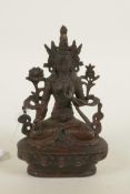 A bronze Buddhistic figure with red patination, 6¼" high