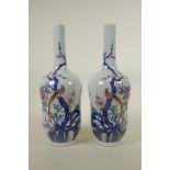 A pair of Chinese blue and white porcelain vases with polychrome enamel decoration depicting Asiatic