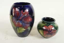 Two Moorcroft vases, a mid C20th Moorcroft 'Hibiscus' pattern squat vase, tube-lined flowers and