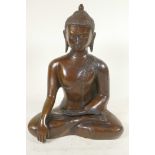 A cast brass figure of Shakyamuni Buddha seated in meditation, 12" high