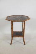 An Oriental octagonal bamboo occasional table with a lacquer top and undertier decorated with