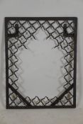 An Indian wrought iron mirror frame with lattice style decoration, 23" x 30"