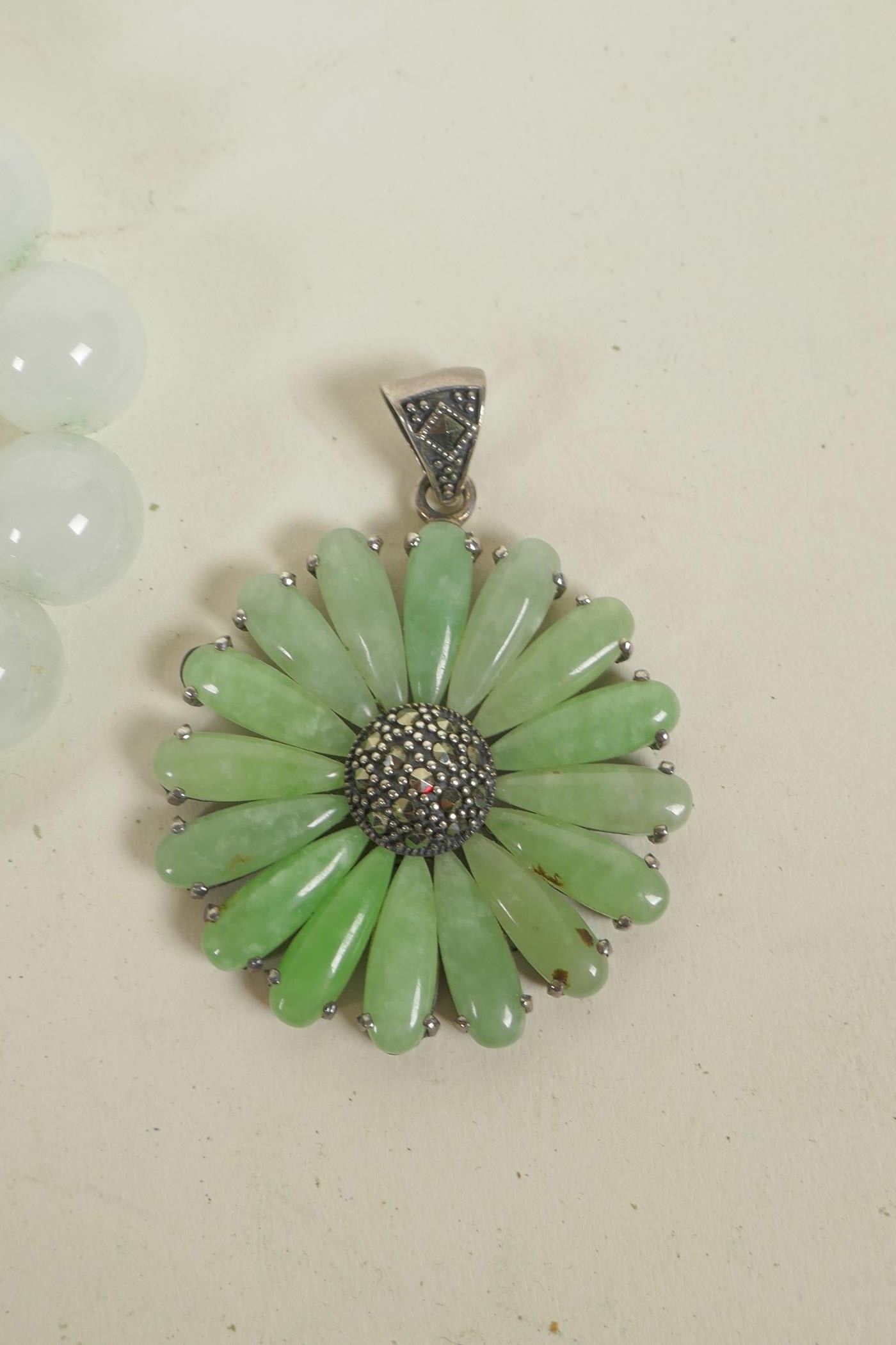 A 925 silver daisy shaped pendant set with green jade and marcasite, together with two jade beaded - Image 2 of 3