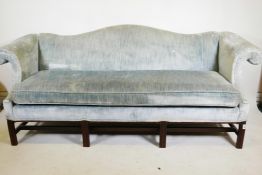 A Chippendale style humpback settee, with scroll arms, raised on moulded square supports, mid C20th,