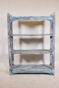 An Indian hardwood four tier open shelf with distressed paintwork, 36" x 12" x 48"