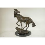 A bronze figure of a horse standing on a rock, signed, 16½" high