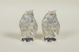 A pair of silver plated salt and pepper cruets in the form of boars' heads, 2" long