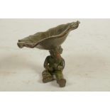 A Chinese bronze figure of a seated boy holding a large lily leaf, 2½" high