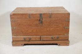 An Indian teak and brass mounted mule chest with hinged, fold over top and two drawers, raised on