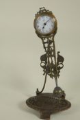 A bronze mystery clock on floral tray base, 11" high