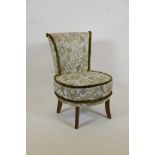 A Victorian nursing chair upholstered in green brocade