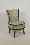 A Victorian nursing chair upholstered in green brocade