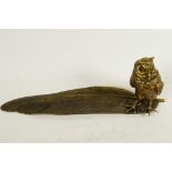 A bronze pen tray and inkwell cast as an owl standing on a large feather, 13½" long