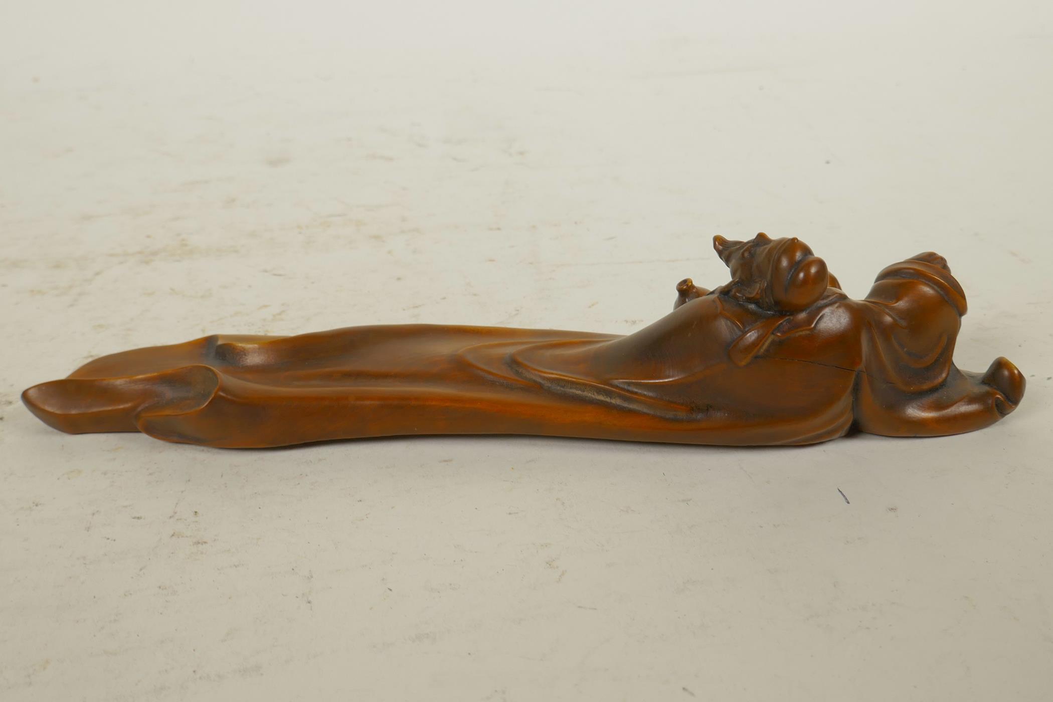 A Chinese boxwood incense stick holder in the form of a reclining sage, 8" long - Image 2 of 2
