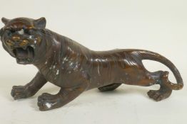 A bronze figure of a roaring tiger, 13" long