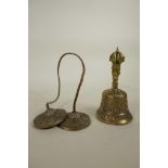 A Tibetan metal bell with vajra decoration to handle, together with a similarly decorated set of