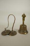 A Tibetan metal bell with vajra decoration to handle, together with a similarly decorated set of