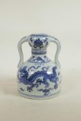 A Chinese blue and white porcelain flask with two handles, decorated with a dragon and phoenix, 4