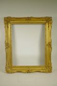 A C19th gilt composition picture frame with C-scroll decoration, rebate 20" x 16"