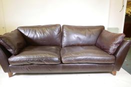 A Marks and Spencer brown leather two seater sofa, 84" wide