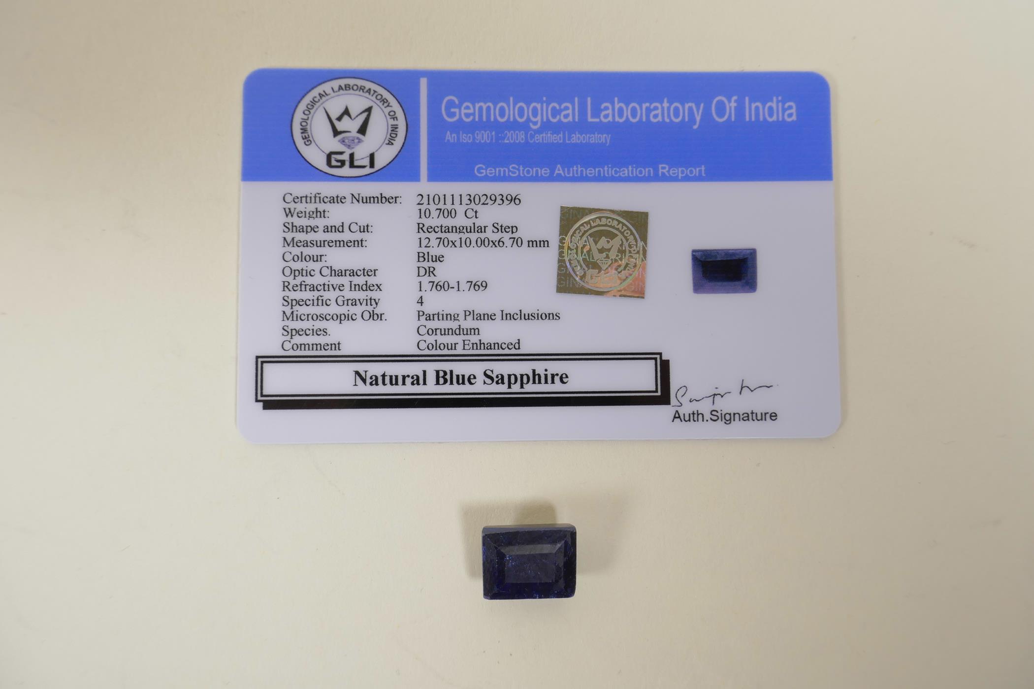 A 10.70ct natural blue sapphire, rectangular step cut, colour enhanced, certified by Gemological