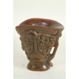 A Chinese faux horn libation cup with mythical animal decoration, 5½" high