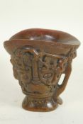 A Chinese faux horn libation cup with mythical animal decoration, 5½" high